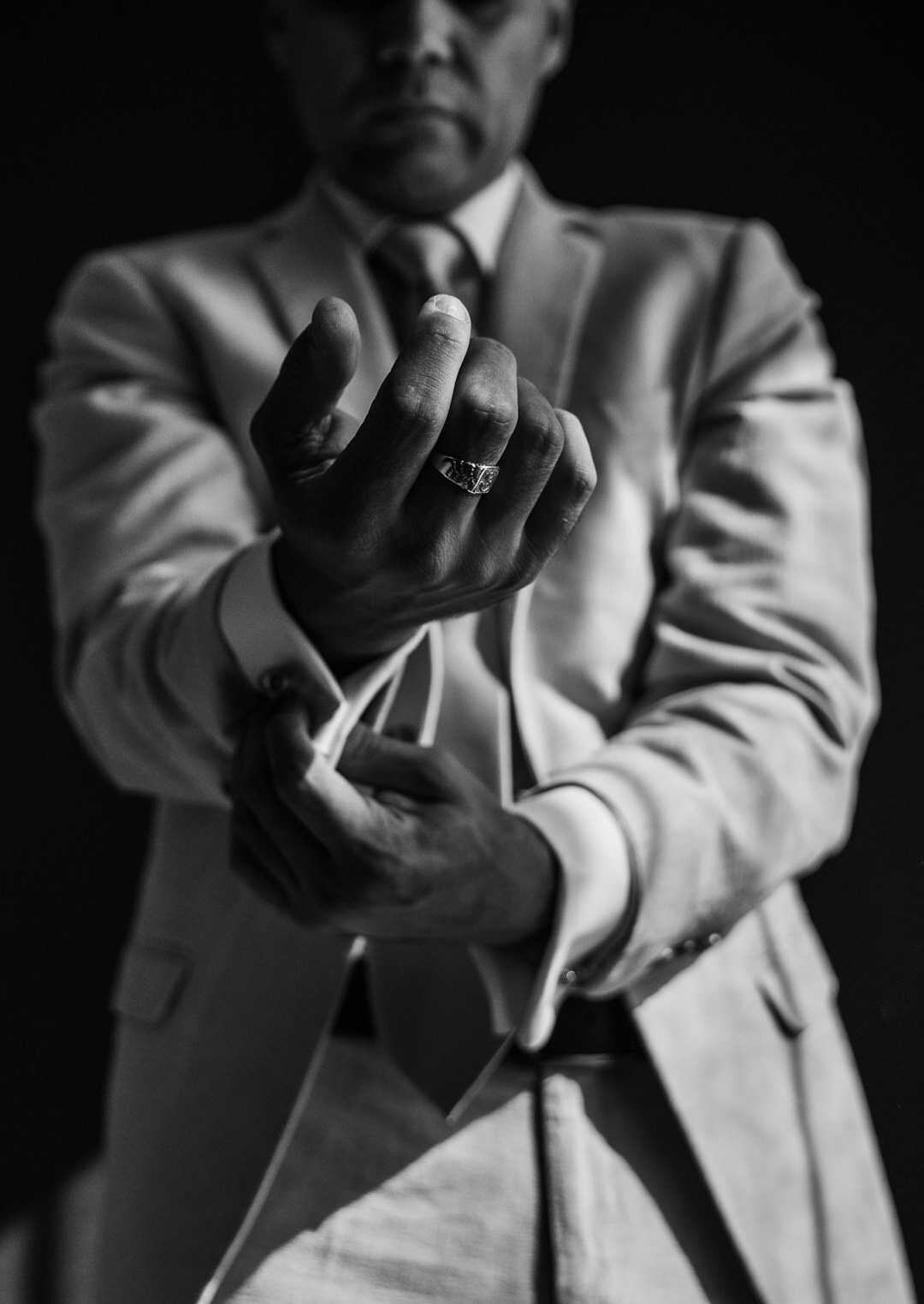 Studio portrait of a Mexican man in his 50s wearing a suit and tie
