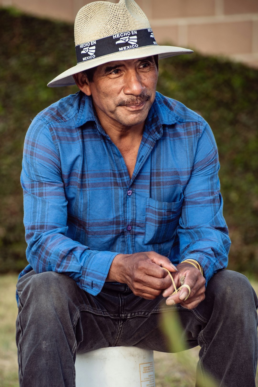 Studio portrait of a Mexican man in his 40s with glasses wearing a suit