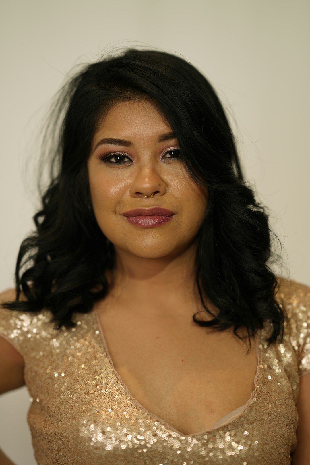Studio portrait of a Mexican woman in her 40s wearing a dark blazer