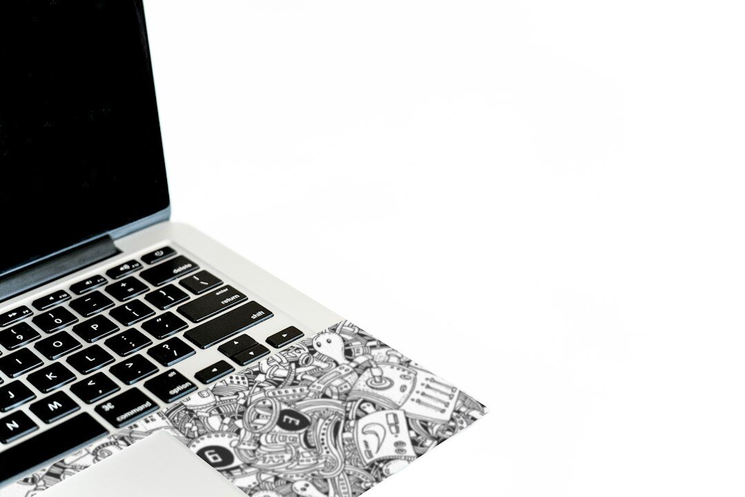 Hands of a Mexican professional typing on a laptop showing financial charts